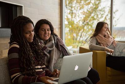 image of RWU students collaborating on a laptop