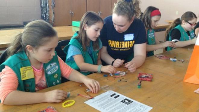 Students mentor Girl Scouts.
