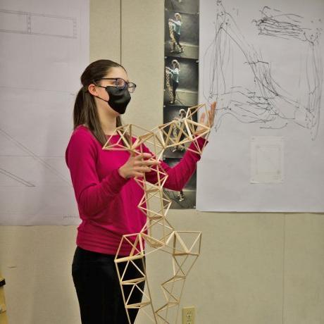 A student presenting her model to the studio